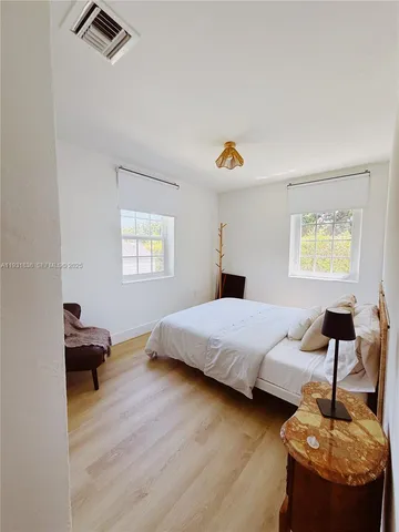 a bedroom with a bed and a couch