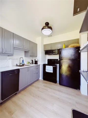 a view of lawn chairs and table on the ocean