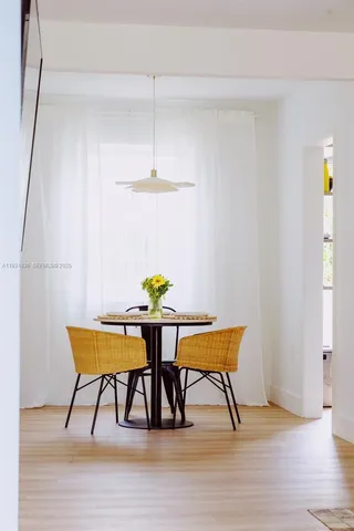 a view of a yard with plants and a bench