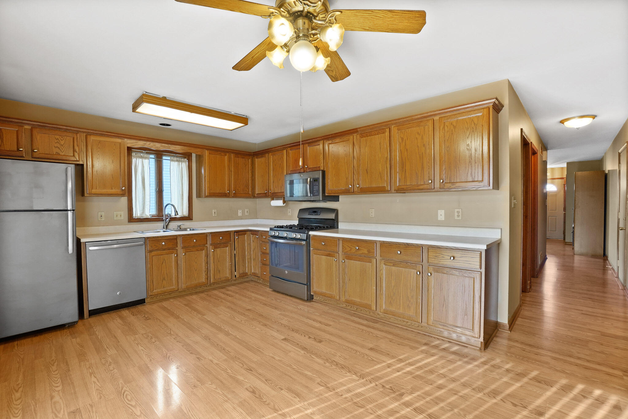 1932 Church Street Dyer, IN 46311 - Photo 5 of 20 a kitchen with granite countertop a refrigerator a sink dishwasher stove and oven