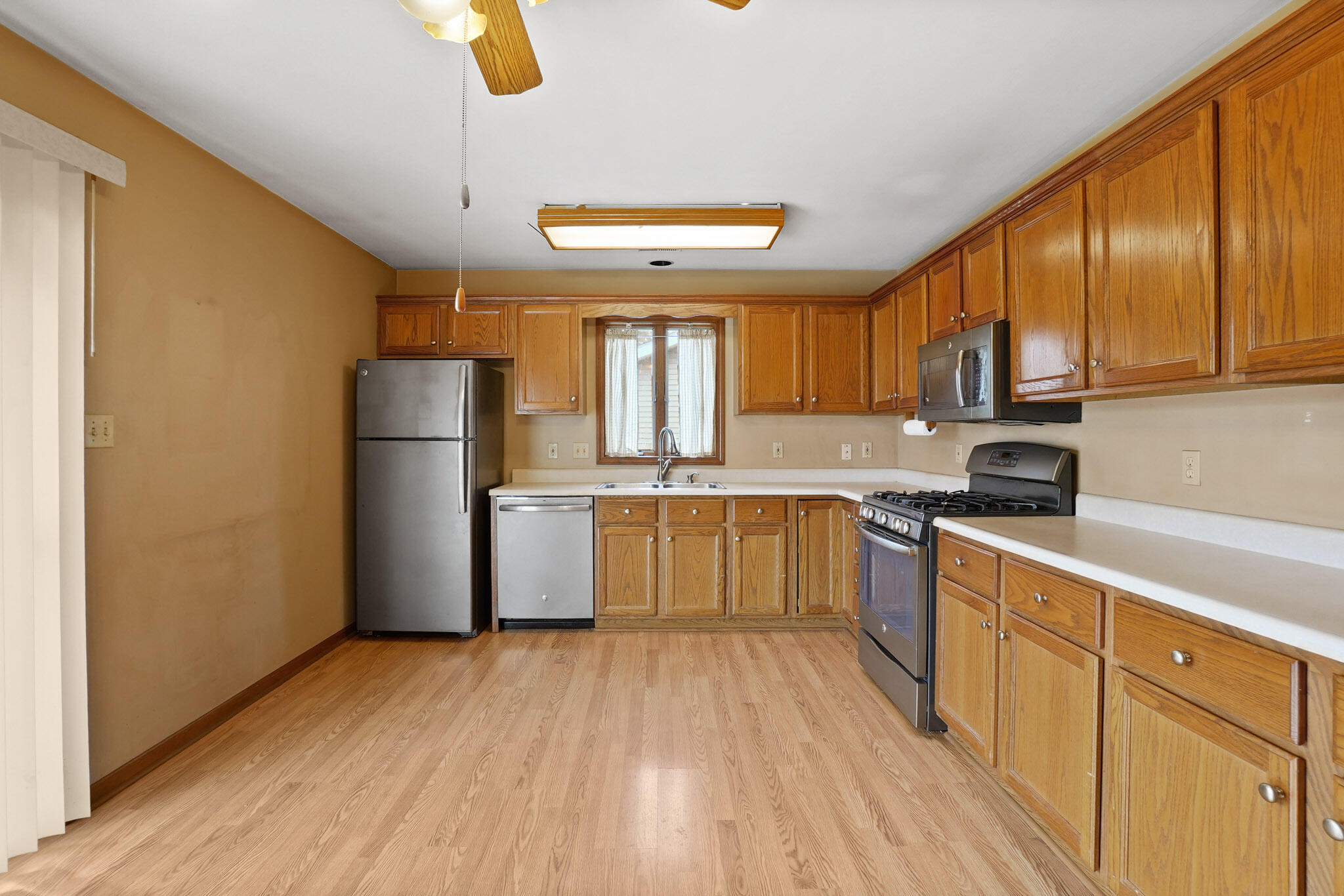 1932 Church Street Dyer, IN 46311 - Photo 7 of 20 a kitchen with sink a refrigerator and wooden floors