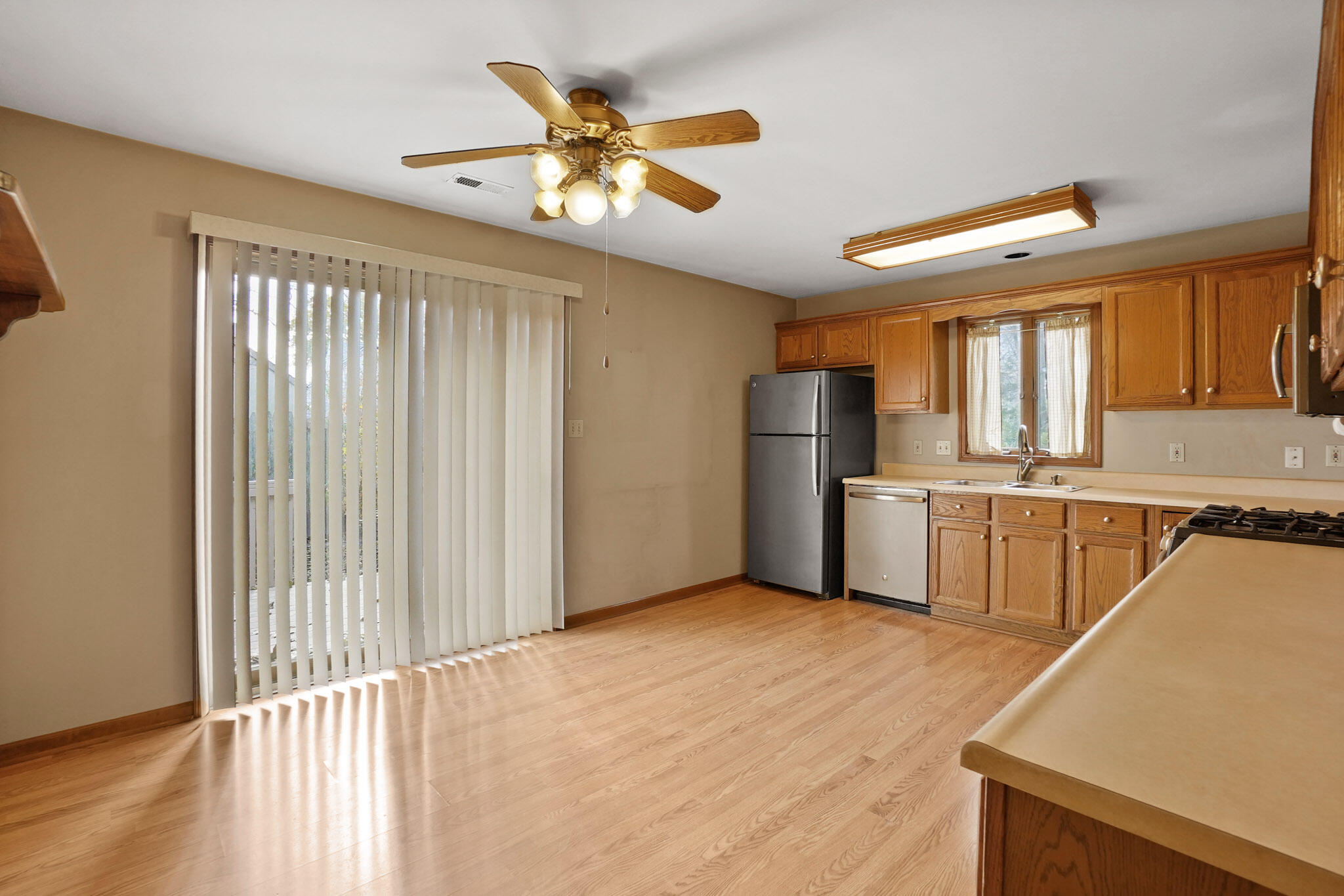 1932 Church Street Dyer, IN 46311 - Photo 8 of 20 a view of a kitchen with wooden floor and a ceiling fan
