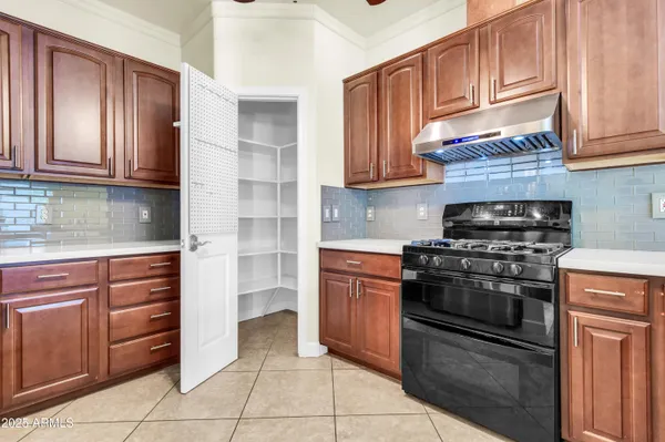 a kitchen with stainless steel appliances granite countertop a stove sink and cabinets