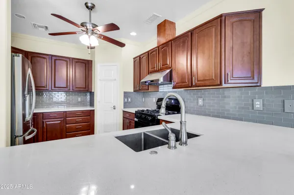 a kitchen with stainless steel appliances granite countertop a stove and a refrigerator