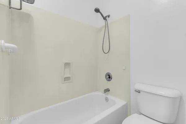 a bathroom with a bath tub with a toilet