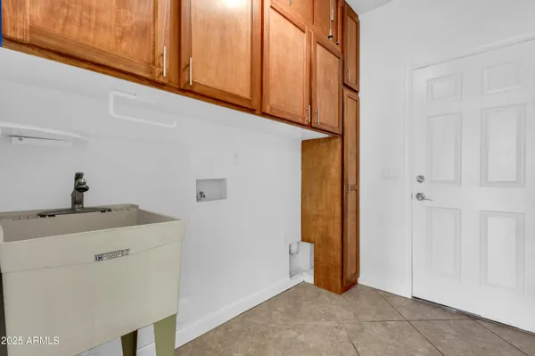 a view of a storage & utility room with a sink