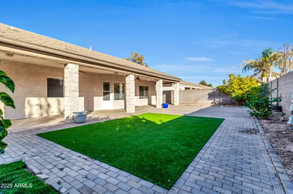 a view of a house with a backyard