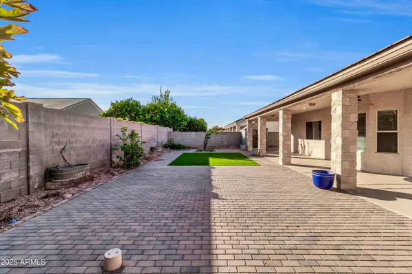 a view of a house with backyard and sitting area
