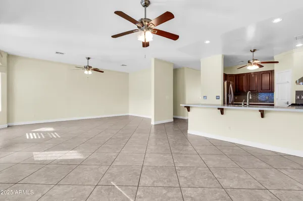a living room with furniture ceiling fan and a rug