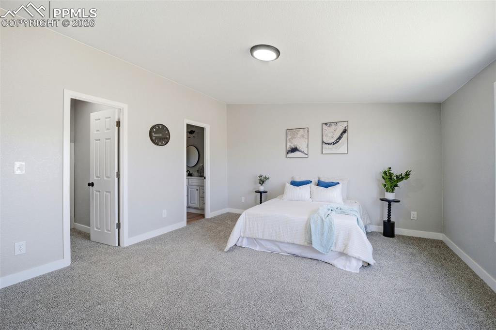 35125 Book Road Yoder, CO 80864 - Photo 10 of 45 a bedroom with a bed and a potted plant