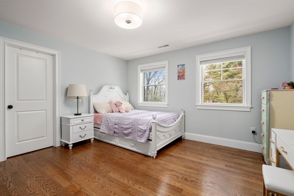 56 Blossomcrest Road Lexington, MA 02421 - Photo 18 of 29 a bedroom with a bed and wooden floor