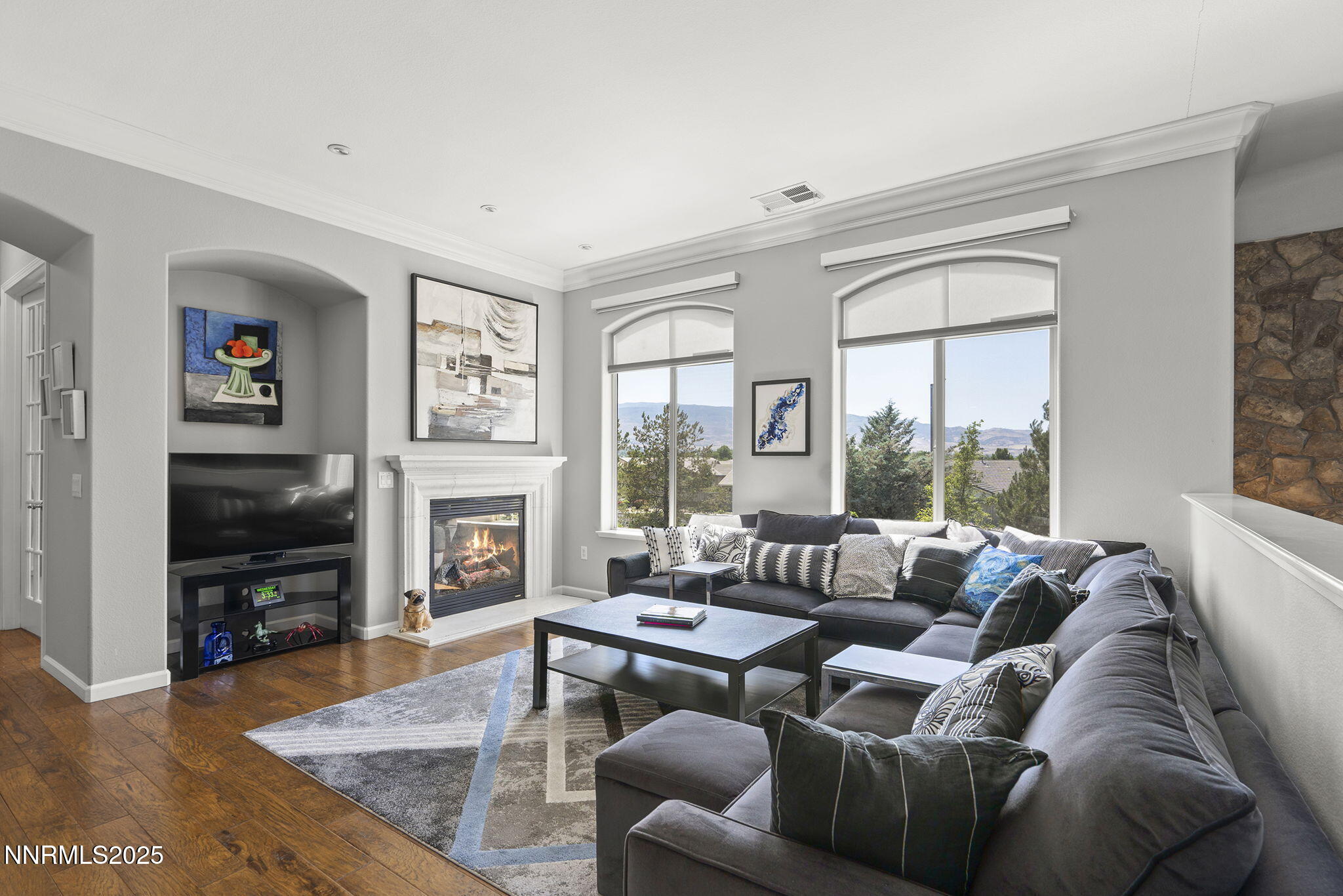 a living room with furniture a flat screen tv and a fireplace