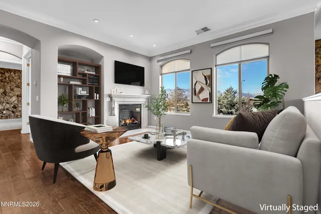 an empty room with windows fireplace and wooden floor