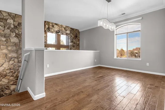 an empty room with windows and painted walls