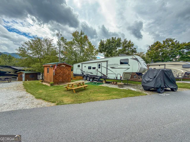 a view of a house with backyard and swimming pool