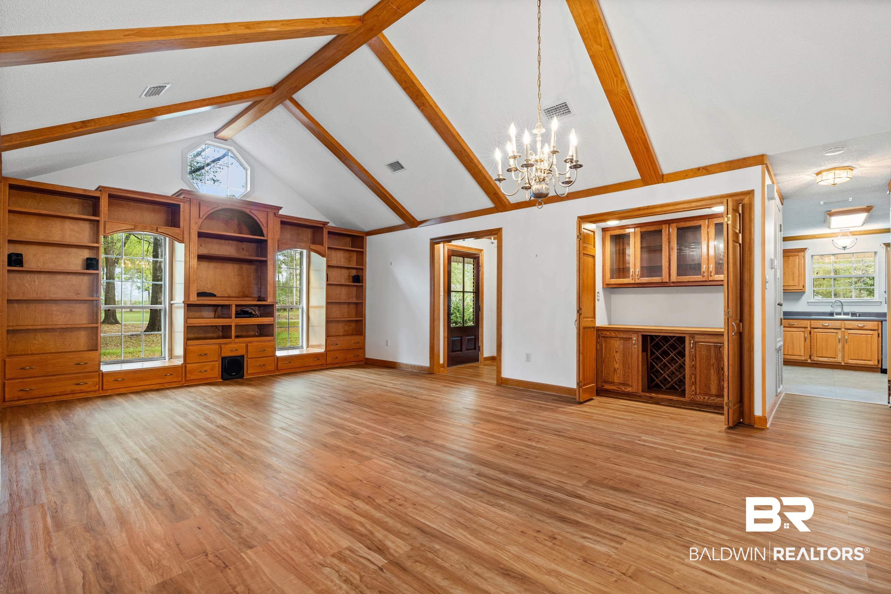 10140 Lakeview Road Bay Minette, AL 36507 - Photo 6 of 35 Unfurnished living room with hanging lights, plenty of natural light, and light wood-style flooring