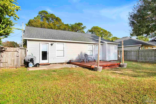 a view of a house with pool and sitting area