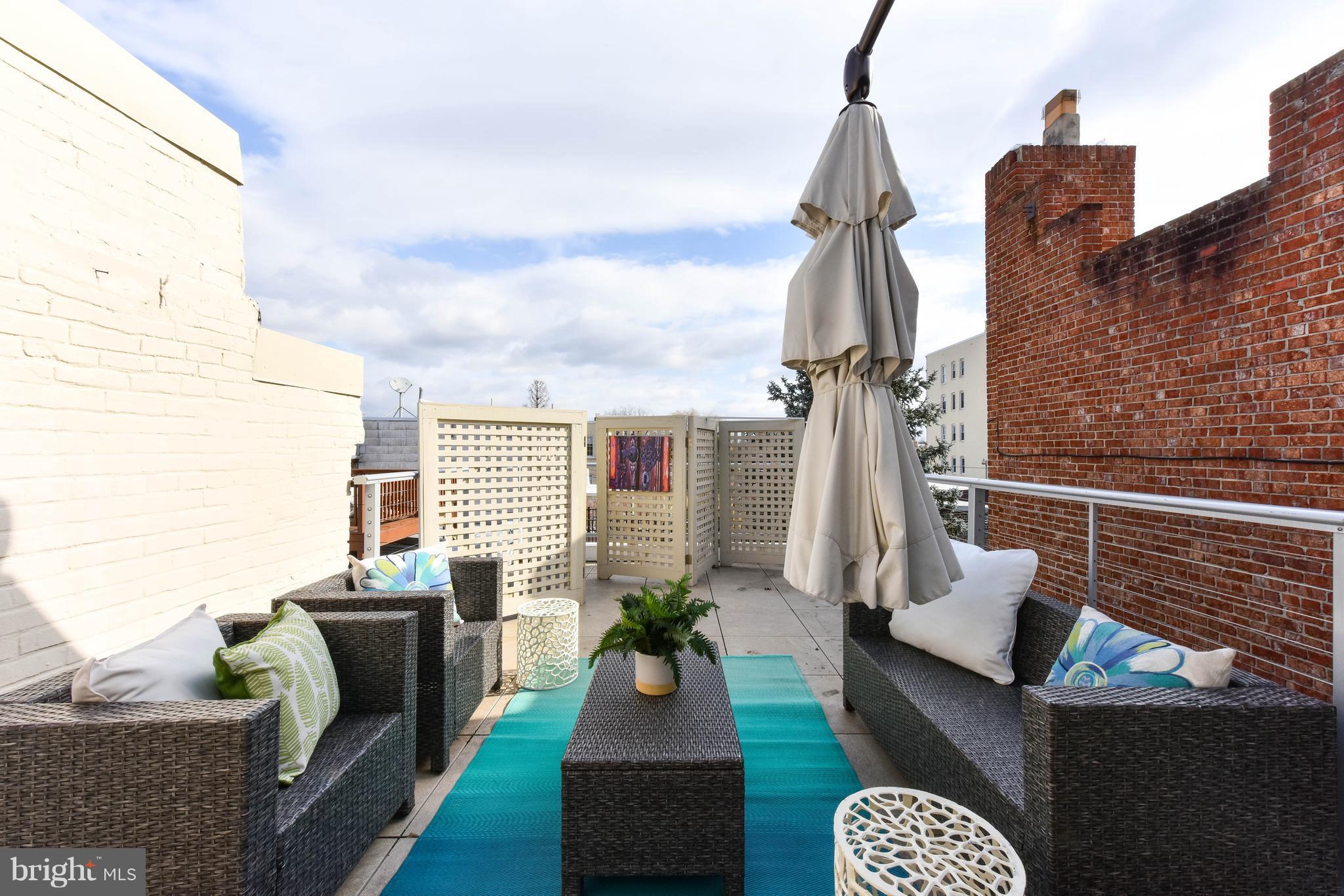 21 3rd Street Northeast Washington, DC 20002 - Photo 28 of 29 a living room with furniture a rug and a chandelier