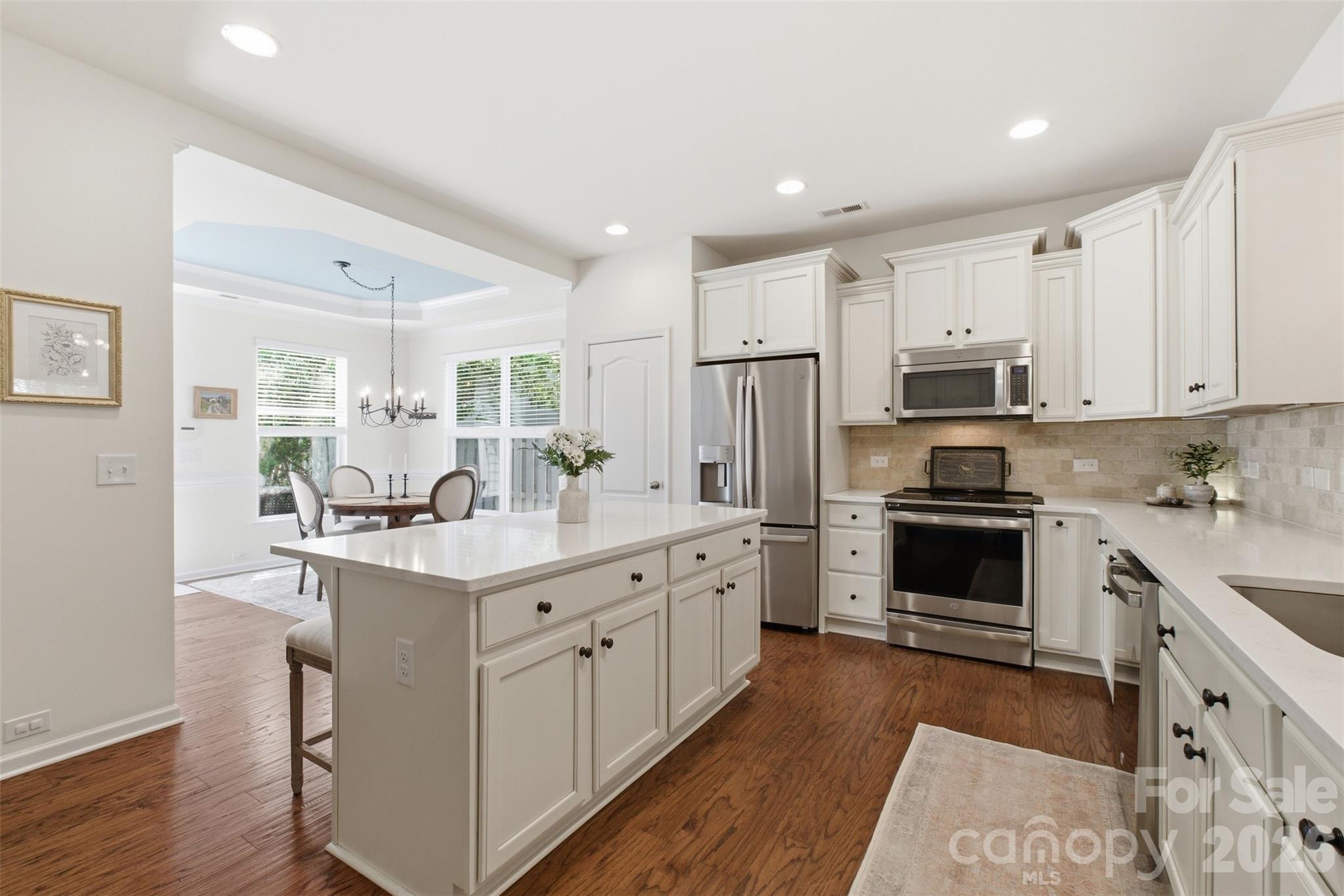 22237 Market Street Cornelius, NC 28031 - Photo 15 of 45 a kitchen with white cabinets and stainless steel appliances