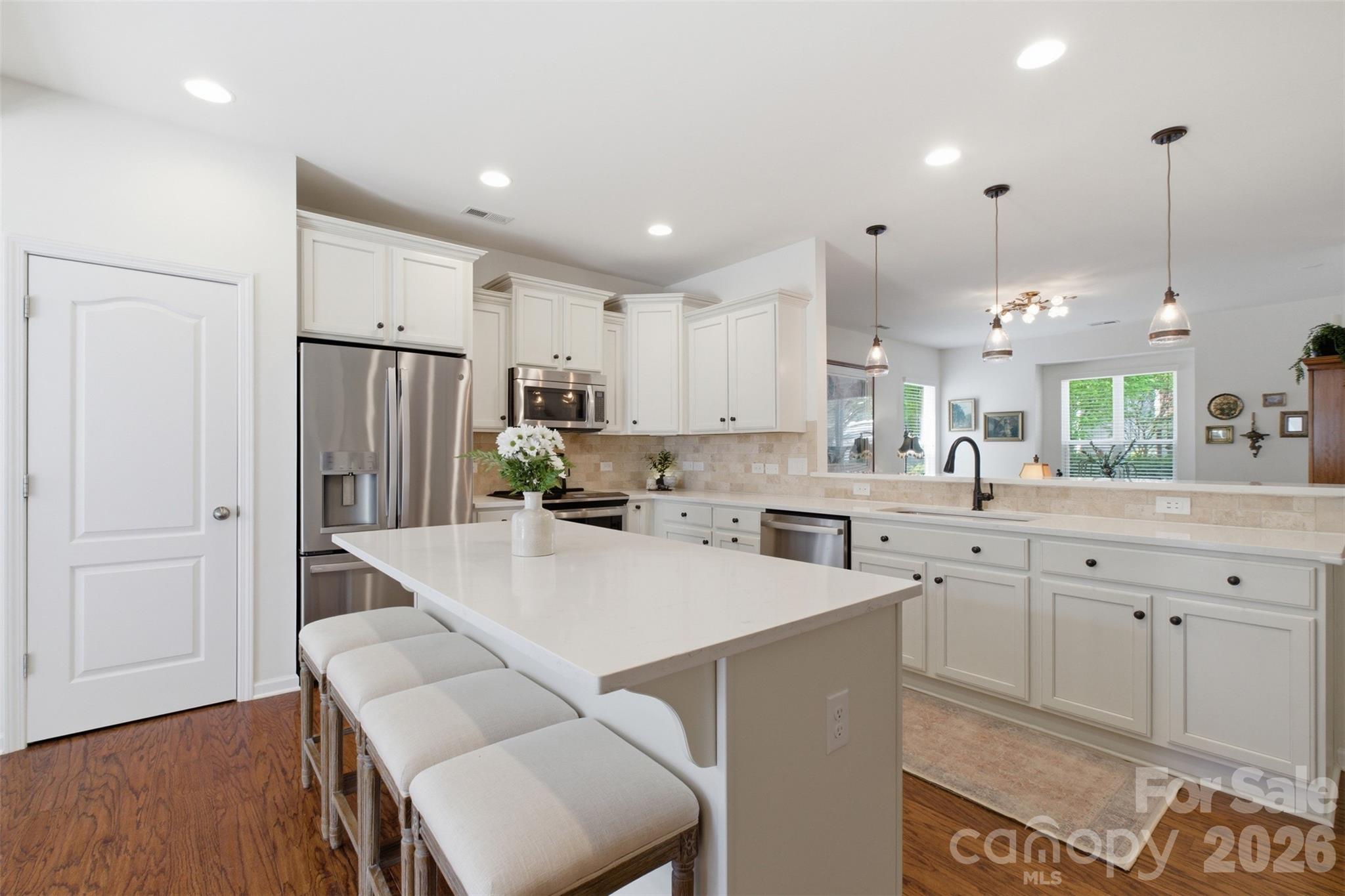 22237 Market Street Cornelius, NC 28031 - Photo 16 of 45 a open kitchen with white cabinets and stainless steel appliances