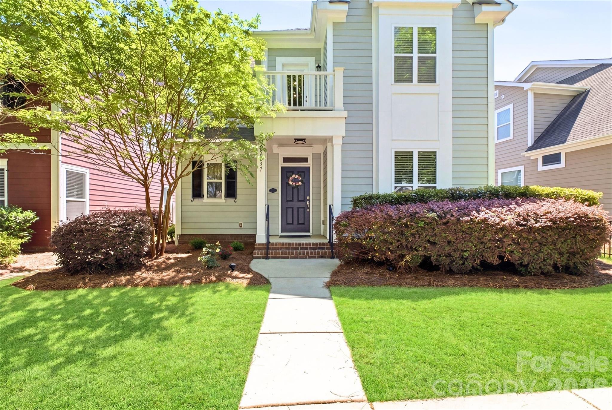 22237 Market Street Cornelius, NC 28031 - Photo 2 of 45 a front view of a house with a garden and plants