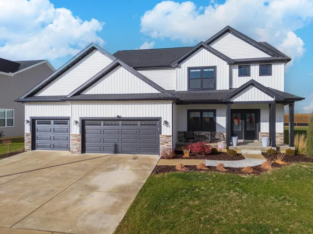 a front view of a house with a yard and garage