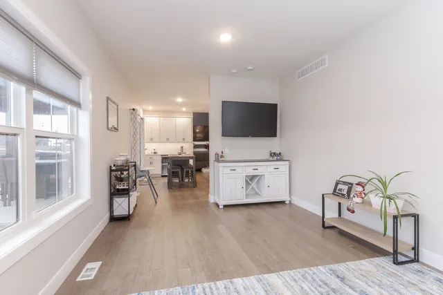 a view of a livingroom with furniture and a flat screen tv