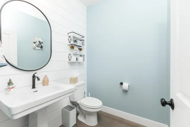 a bathroom with a sink mirror toilet and vanity