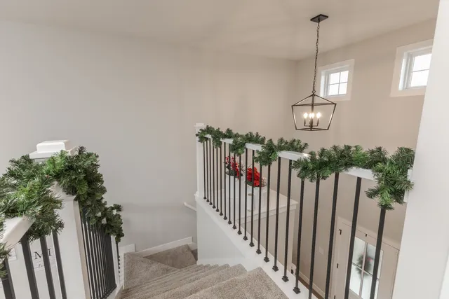 a view of a hallway with wooden floor and stairs