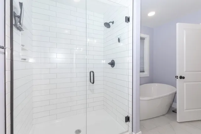 a bathroom with a bathtub and shower