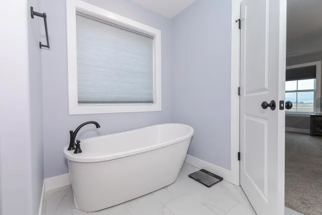 a white bath tub sitting next to a white sink