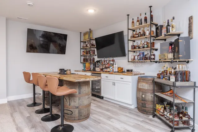 a room with a workspace and a flat screen tv