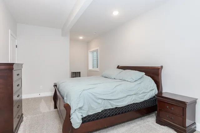 a bedroom with a bed and a night stand