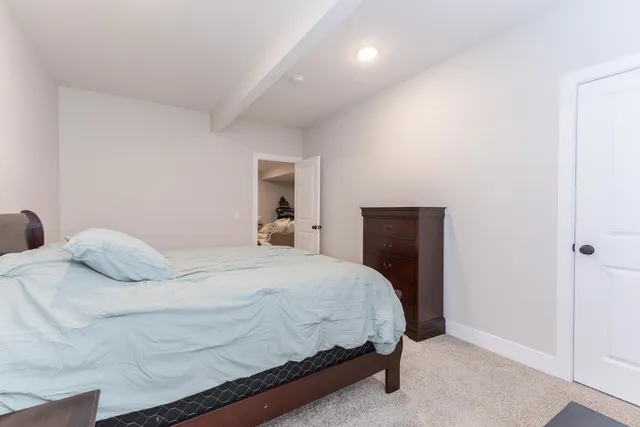 a bedroom with a bed and a painting