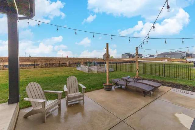 a view of a patio with couches chairs and a yard