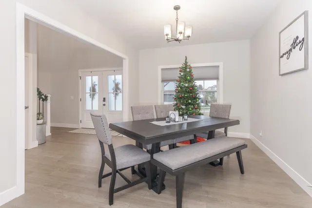 a view of a dining room with furniture and chandelier