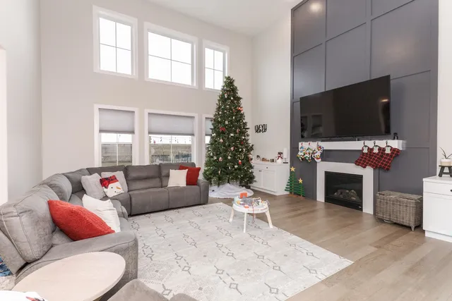 a living room with furniture a flat screen tv and a fireplace