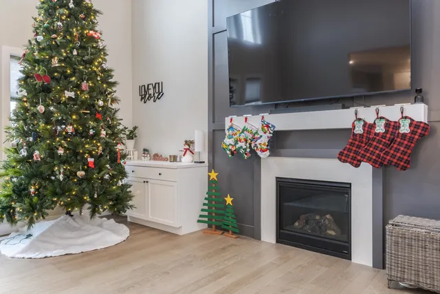a living room with a fireplace a chandelier and pool table
