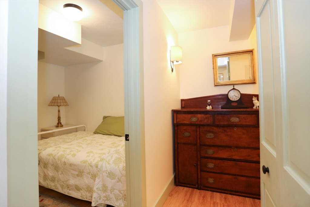 24 Pershing Road, Unit 24 Needham, MA 02494 - Photo 21 of 39 a bedroom with a bed and a dresser
