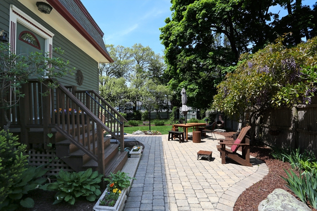 24 Pershing Road, Unit 24 Needham, MA 02494 - Photo 5 of 39 a view of a patio with couches table and chairs and potted plants
