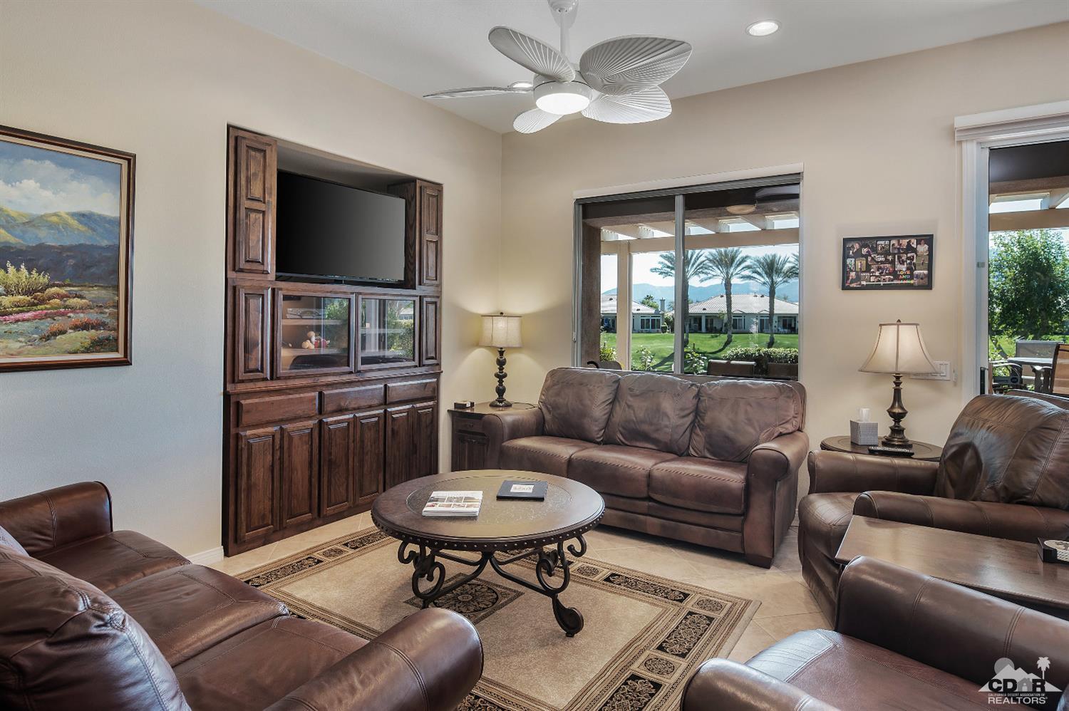 80557 Knightswood Road Indio, CA 92201 - Photo 11 of 30 a living room with furniture a flat screen tv and a window
