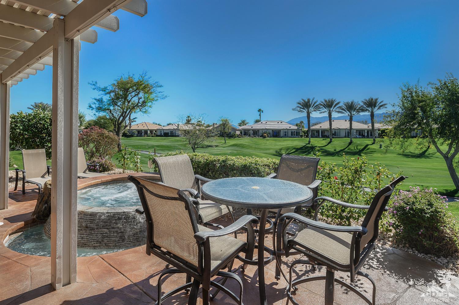 80557 Knightswood Road Indio, CA 92201 - Photo 19 of 30 a view of a chairs and table in patio with a yard