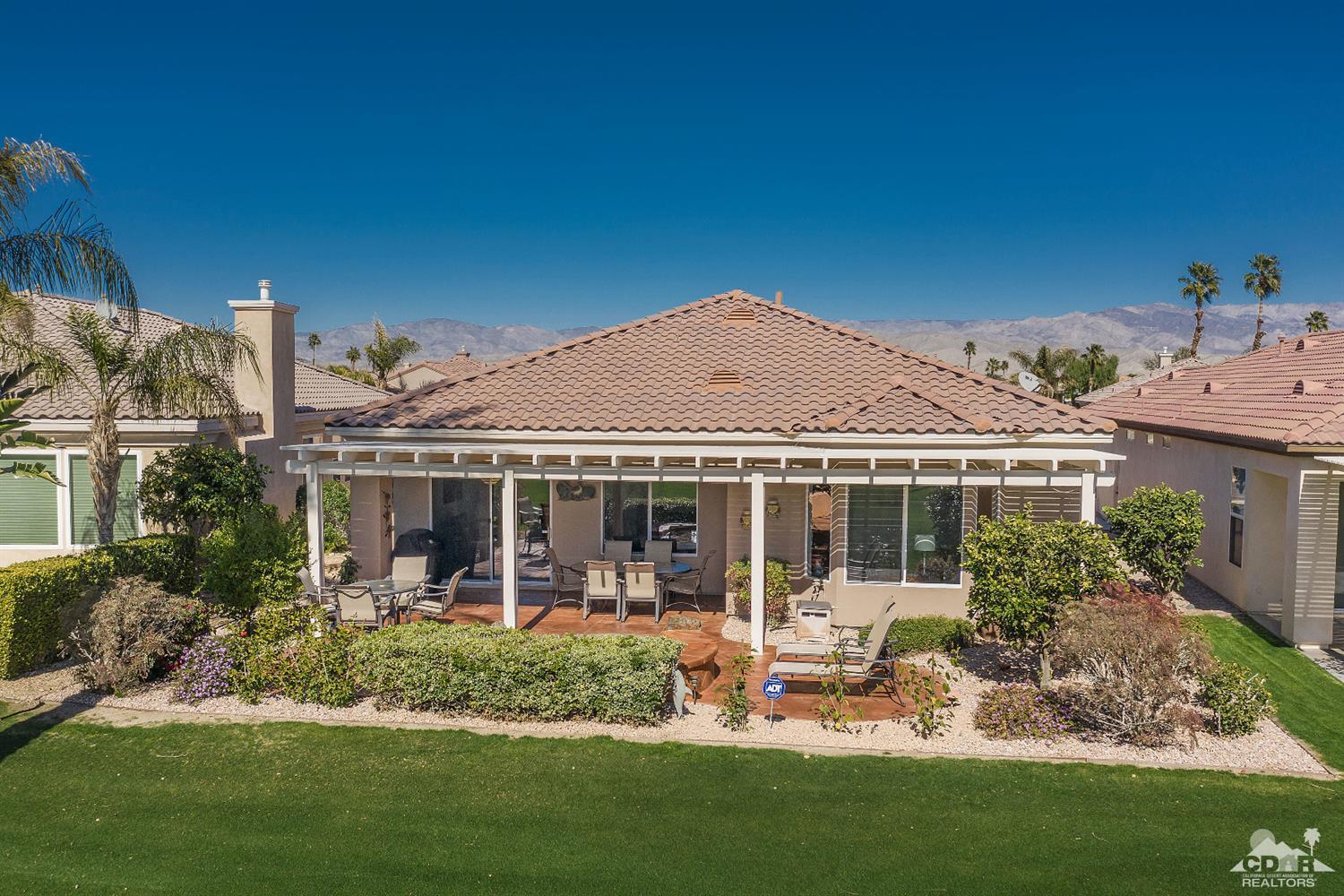 80557 Knightswood Road Indio, CA 92201 - Photo 3 of 30 a front view of a house with a garden and plants