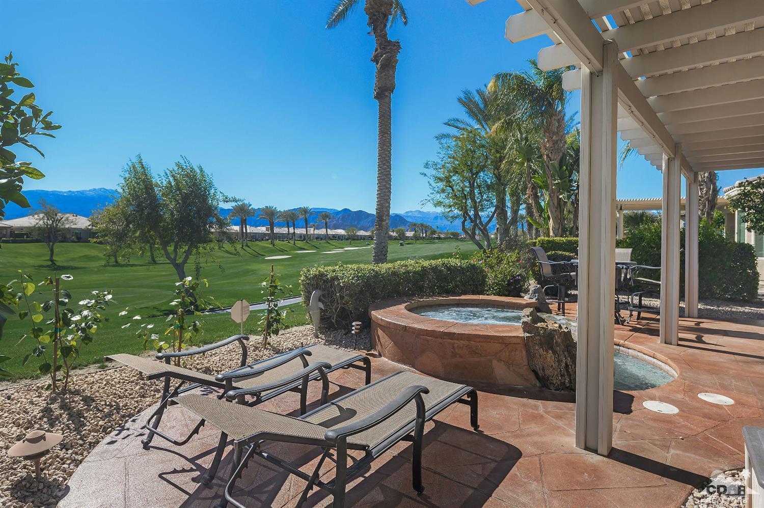 80557 Knightswood Road Indio, CA 92201 - Photo 22 of 30 a view of a patio with a table chairs and a yard