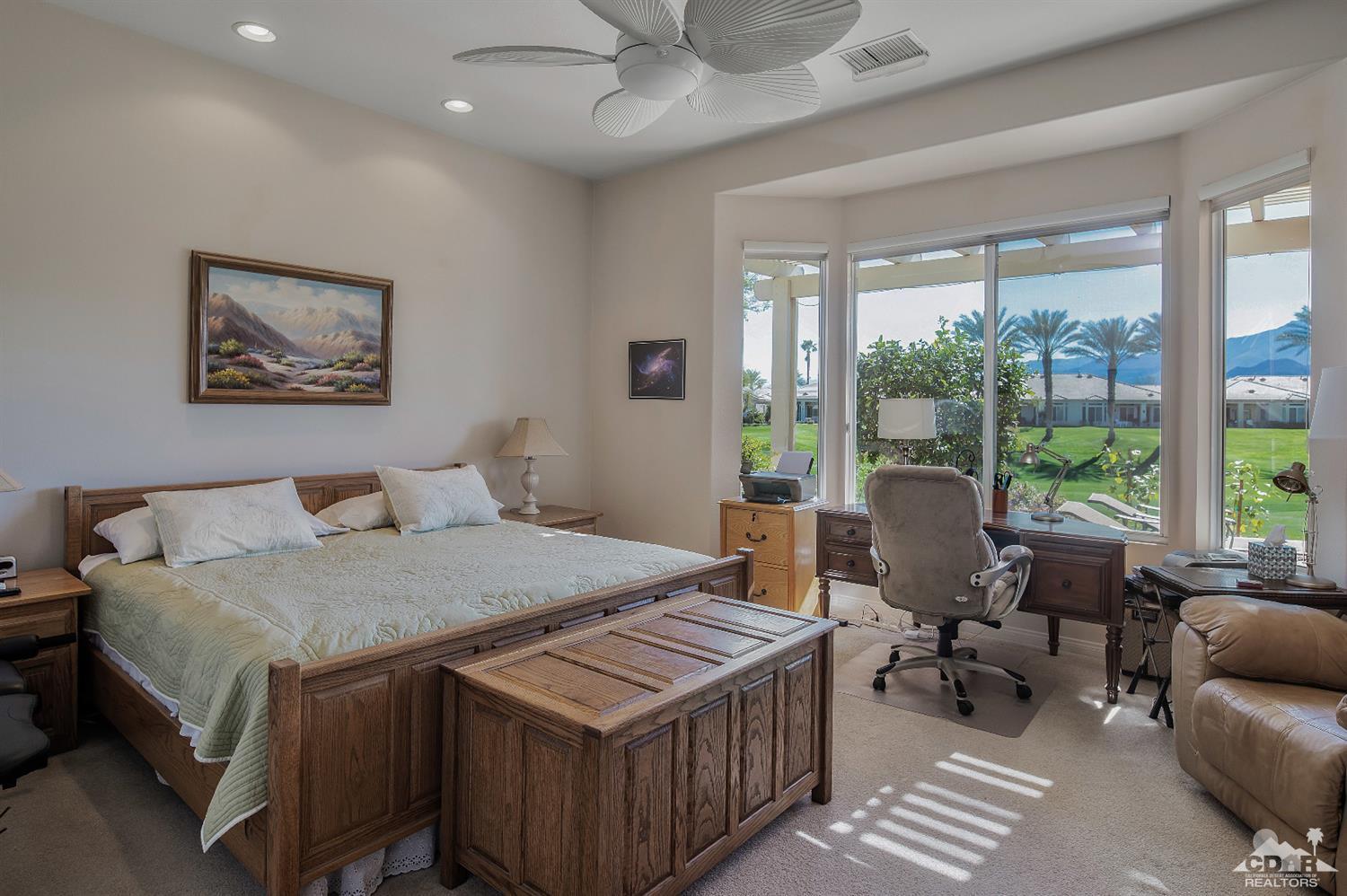 80557 Knightswood Road Indio, CA 92201 - Photo 25 of 30 a bedroom with a bed a table and a potted plant