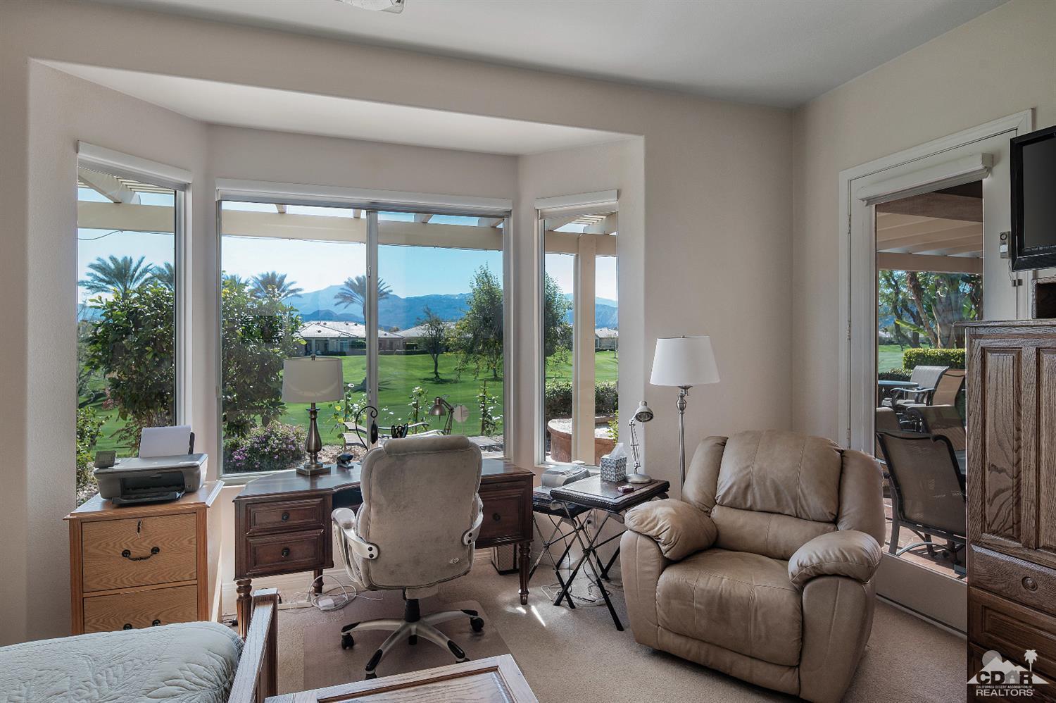 80557 Knightswood Road Indio, CA 92201 - Photo 26 of 30 a living room with furniture a large window and a floor to ceiling window