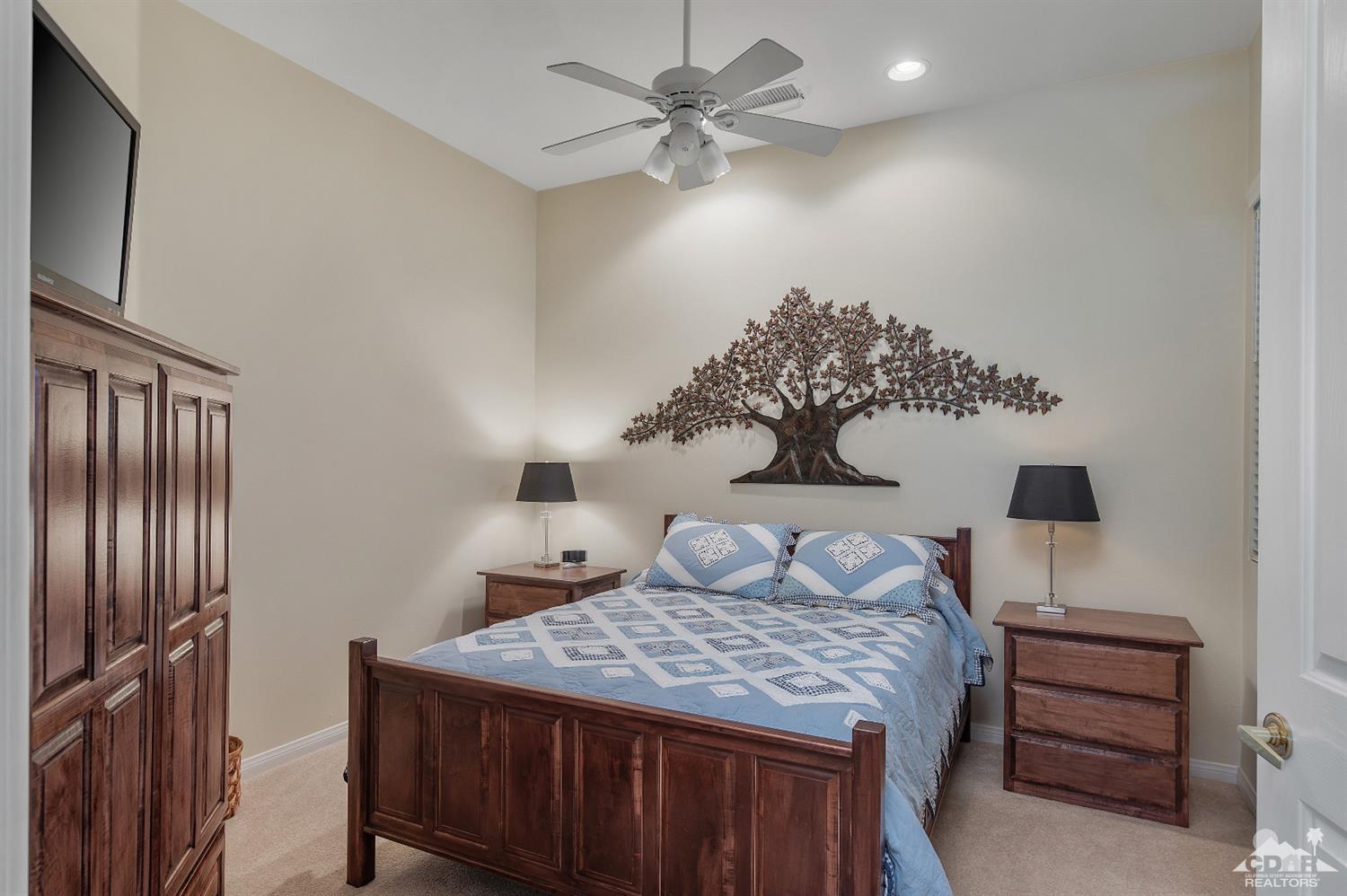 80557 Knightswood Road Indio, CA 92201 - Photo 30 of 30 a bedroom with a bed and a chandelier