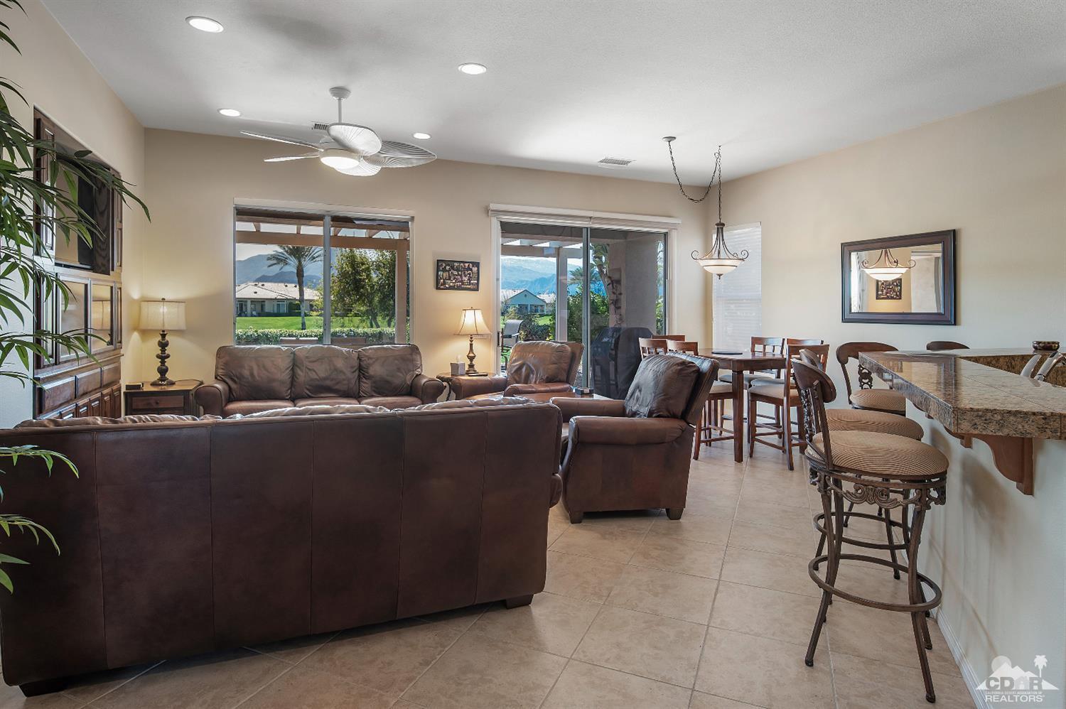 80557 Knightswood Road Indio, CA 92201 - Photo 10 of 30 a living room with furniture a large window and a flat screen tv