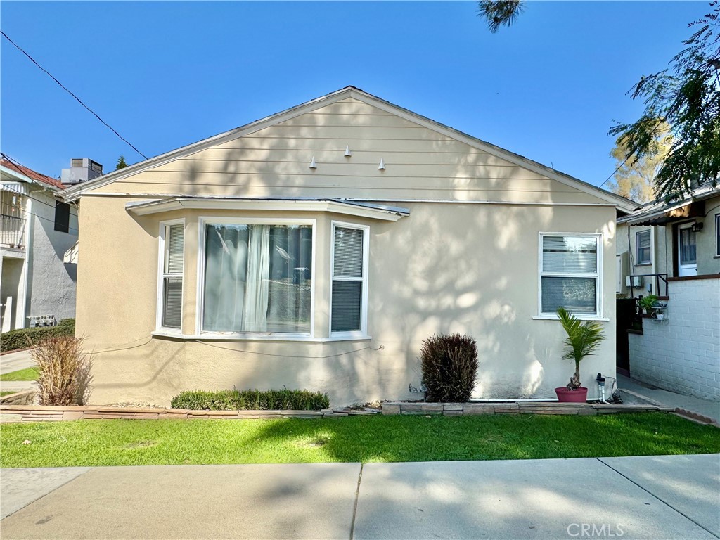 13751 Penn Street Whittier, CA 90602 - Photo 15 of 17 a front view of a house with a yard and garage