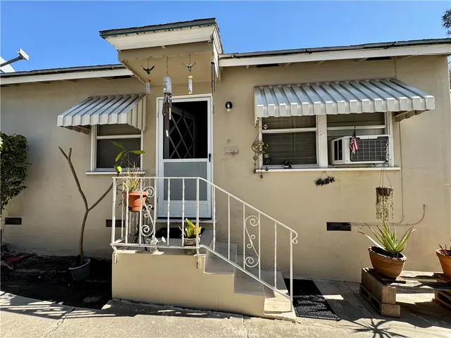 a view of a house with more windows and potted plants